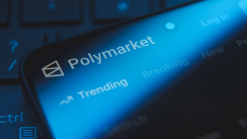 The name Polymarket illuminated on a digital screen. Prediction markets have existed in the U.S. in various forms for decades. (Dreamstime/TCA)