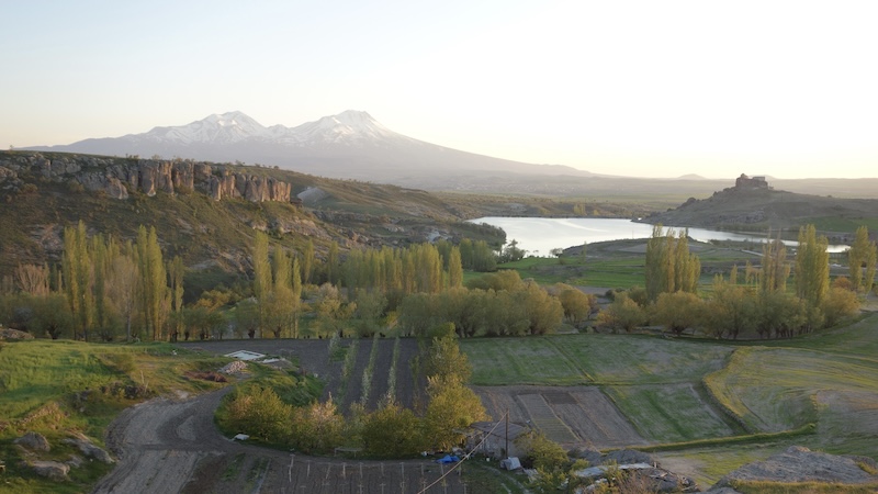 The snowy volcanic slopes of Mount Hasan’s double peaks rule the horizon of Cappadocia, keeping watch over Güzelyurt in Turkey. CREDIT: Rick Steves, Rick Steves’ Europe.