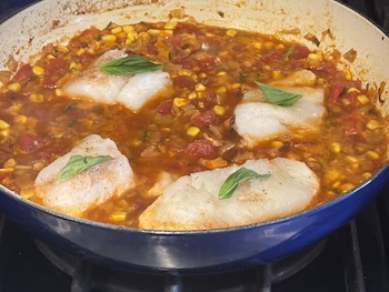 Steamed cod with corn and tomato sauce