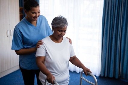 A nurse helping a woman at an assisted living facility as part of life plan communities