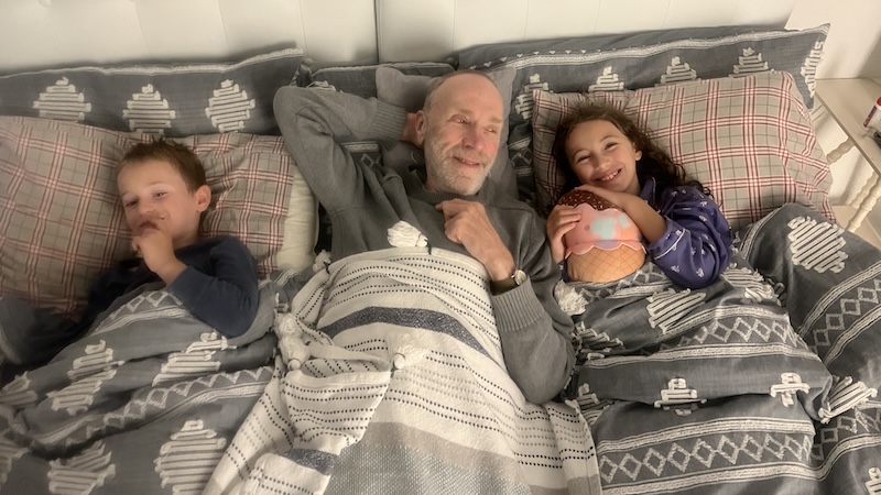 Alan Ripp telling bedtime stories of his childhood mischief to his two grandkids.